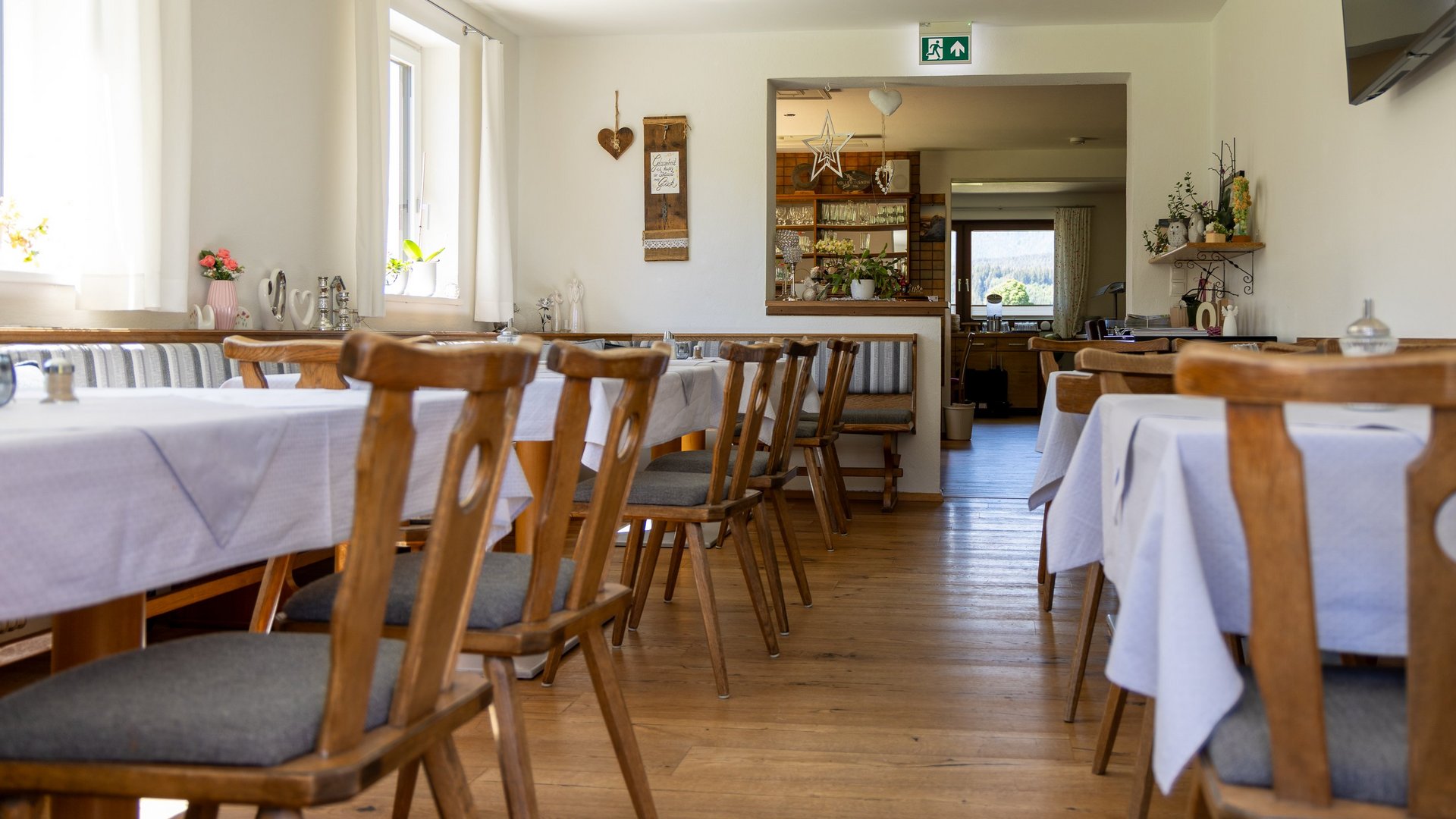 Charming dining area with wooden furnishings Restaurant interior featuring wooden tables and chairs in a cozy layout with natural light